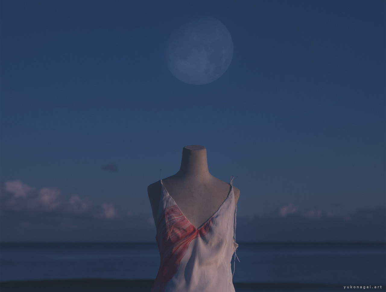 A dress with dyed abstract petal by the shore under the moon.