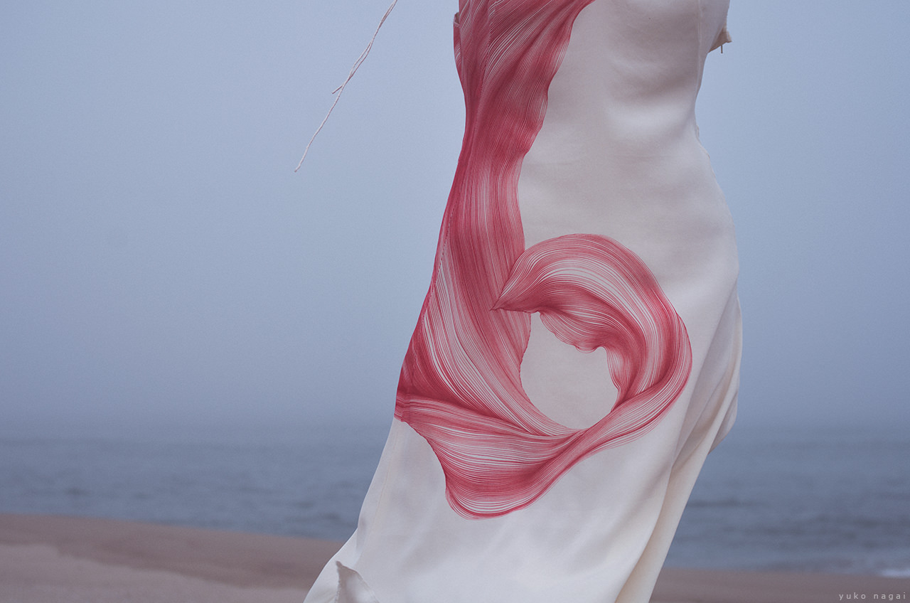 A hand painted dress on the shore.
