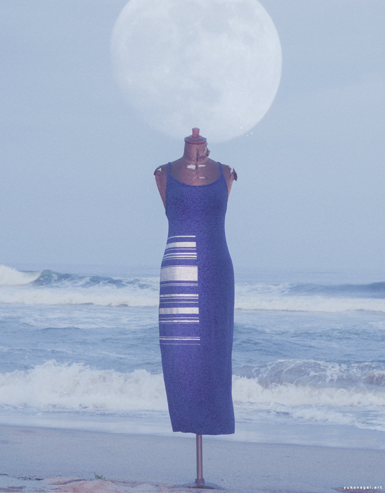 A dress with painted barcode by sea shore with moon overlay.