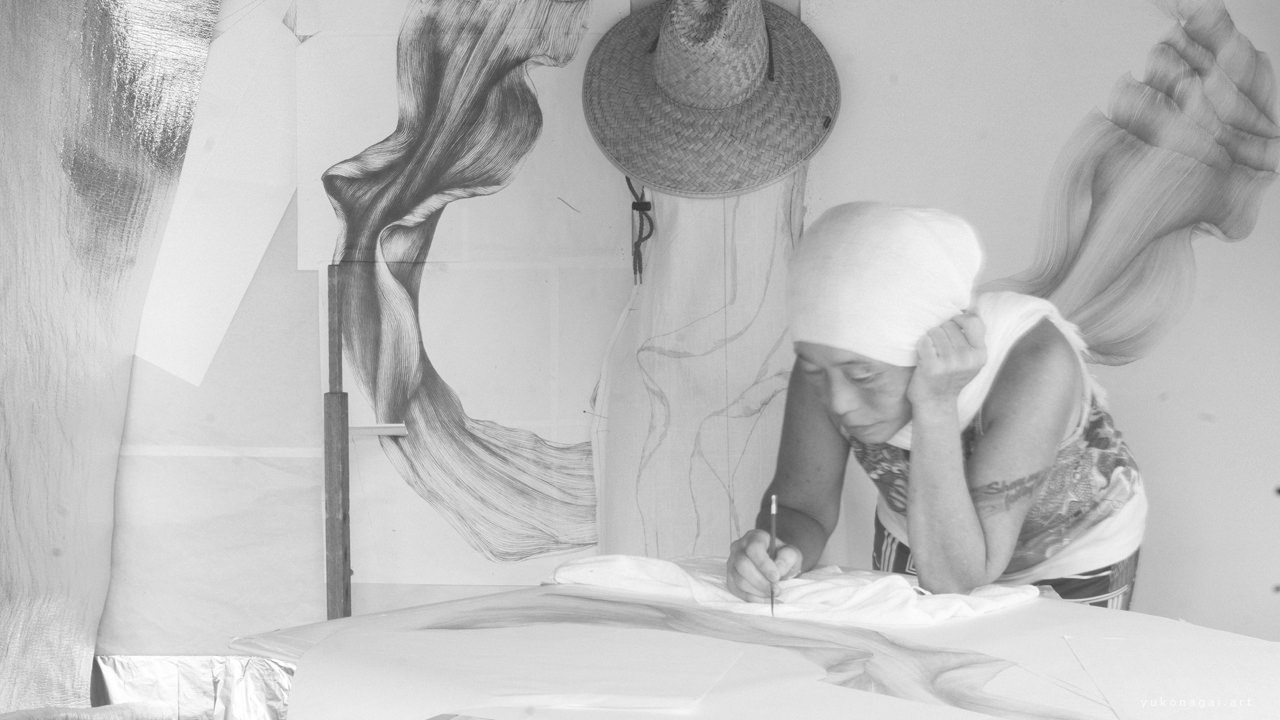 Artist painting in her studio.