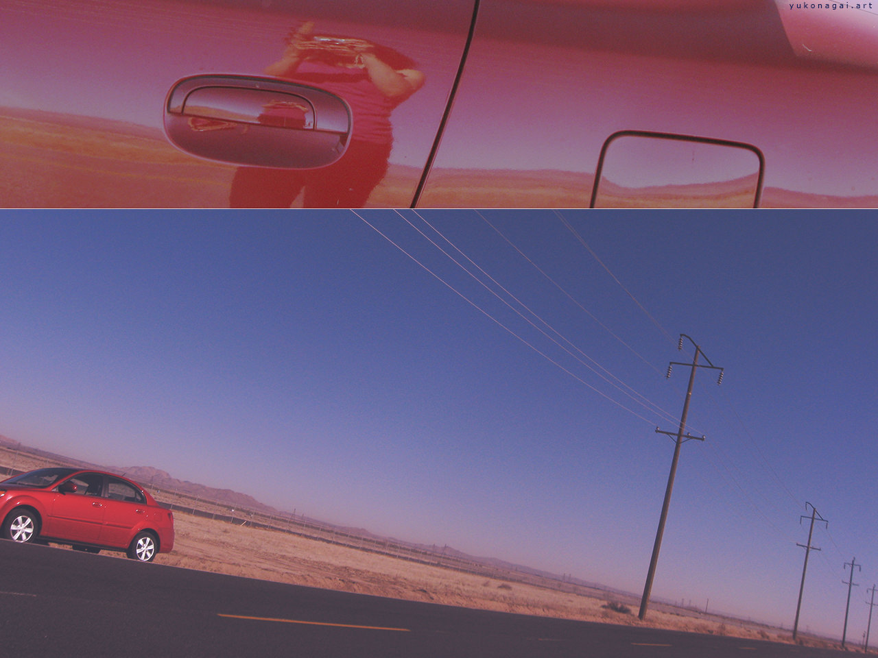 A red car parked by a desert road, and the photographer's reflection on car window.