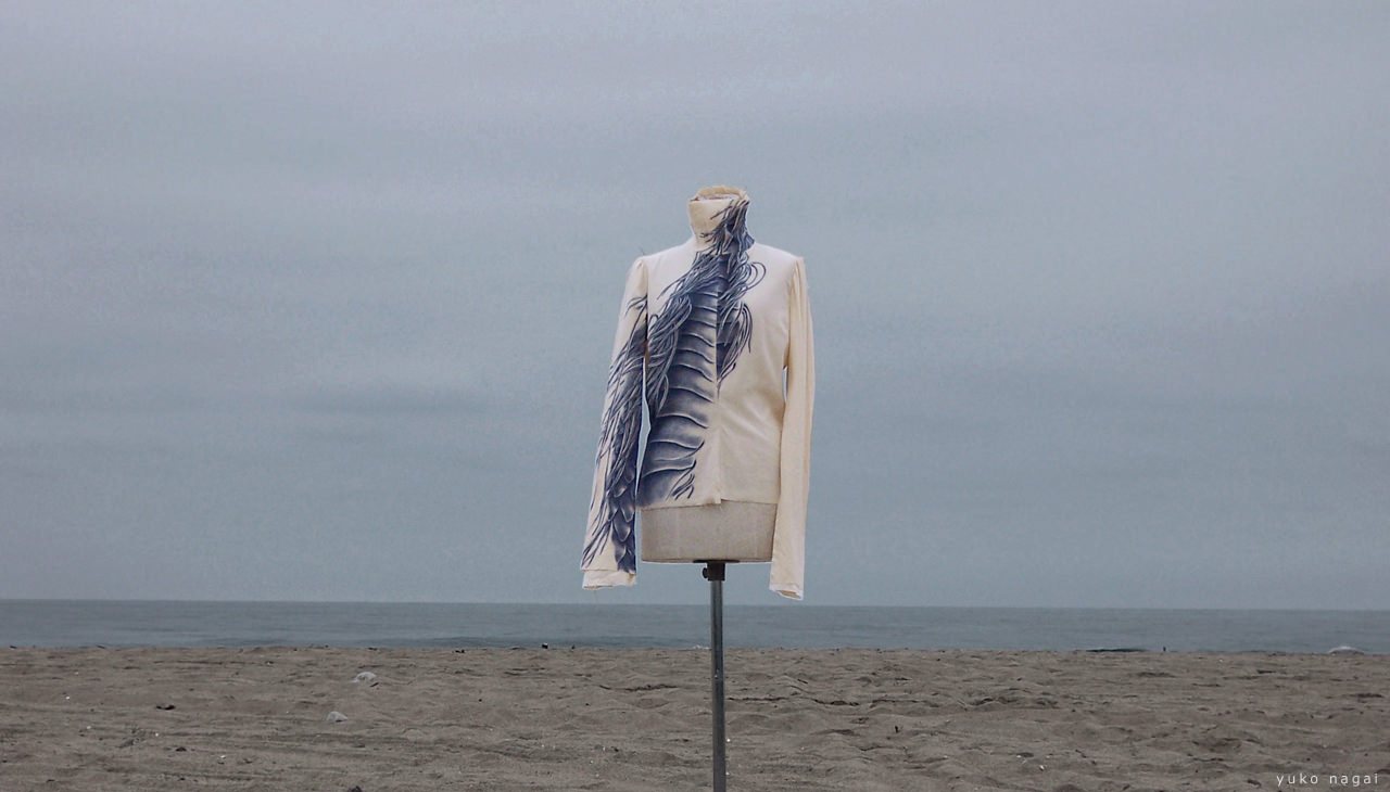 A hand painted blouse on the beach.
