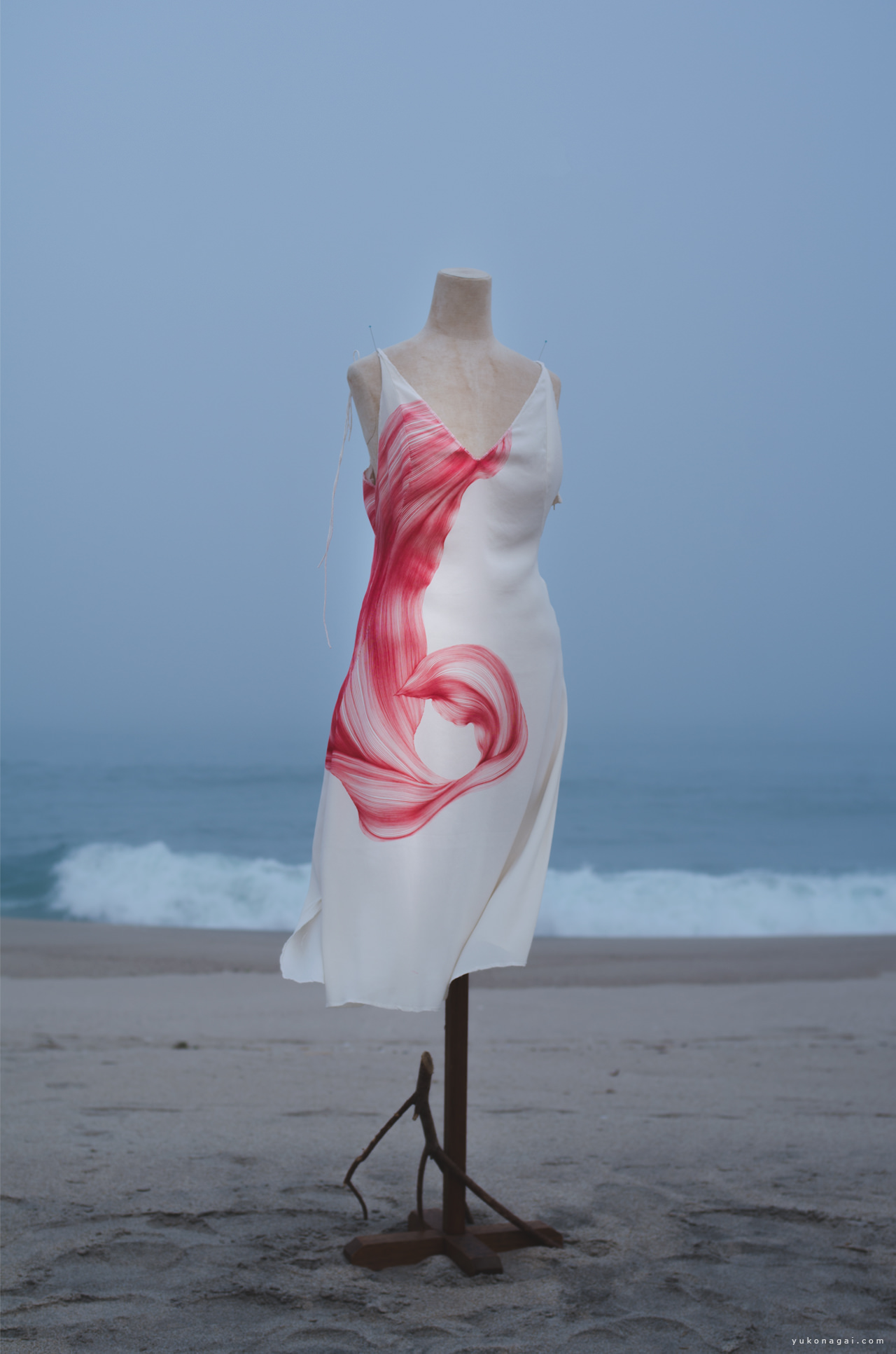 Dress with a dyed lily petal on the beach.