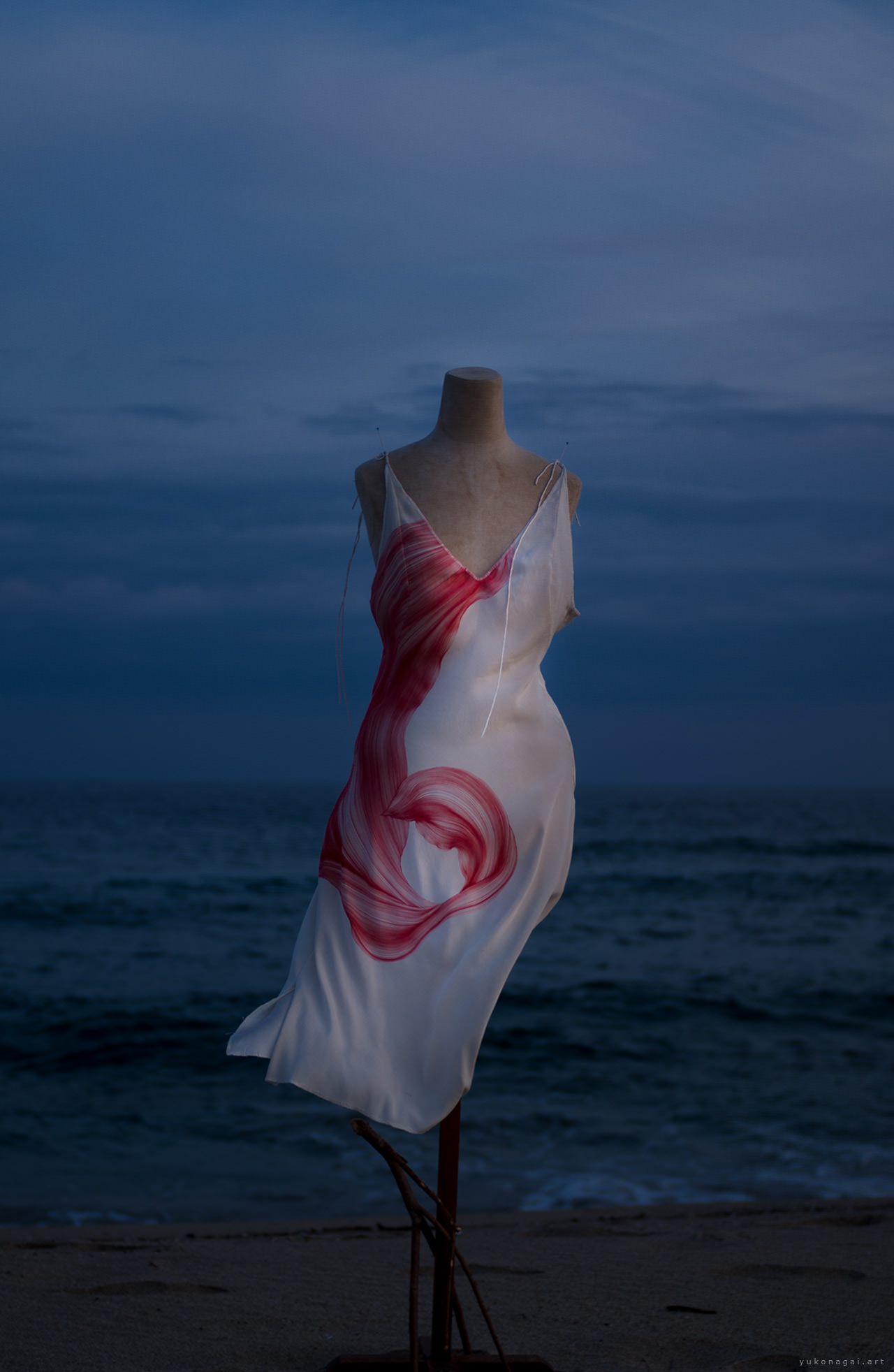 A dress with an abstract painting of a spider lily petal.