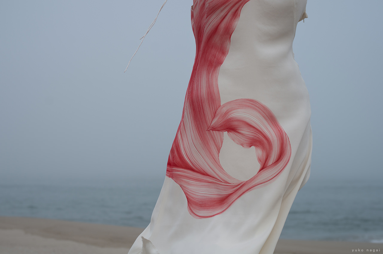 A hand painted dress on the beach.