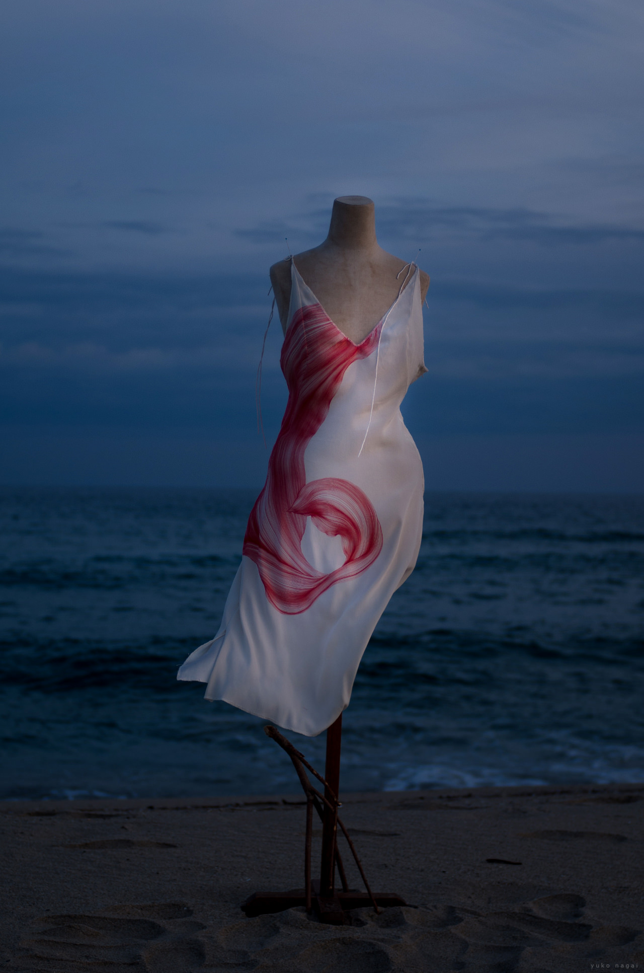A dress with an abstract painting of a spider lily petal.